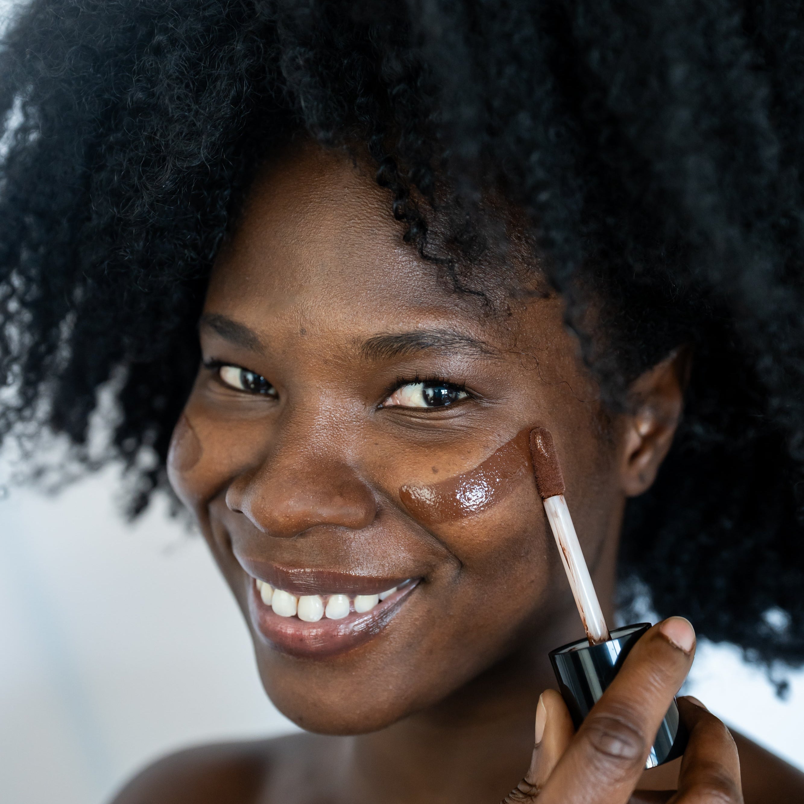 Woman applying makeup (foundation) with a brush
